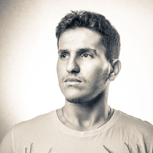 Black-and-white portrait of a man in a plain shirt.